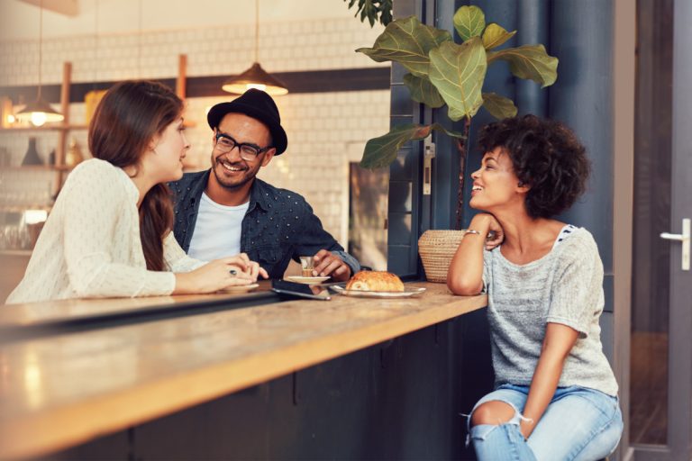 latinos meeting and greeting in a cafe